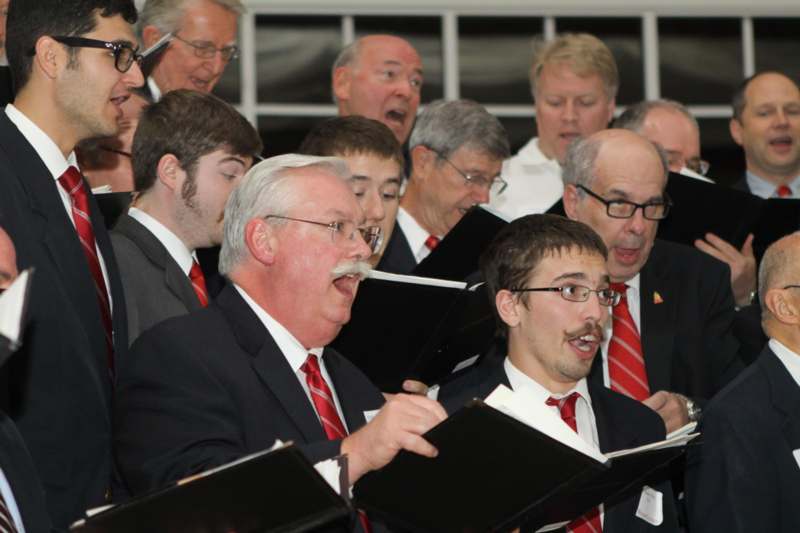 a group of men singing in a choir