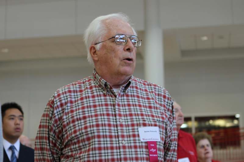 a man wearing glasses and a red and white plaid shirt