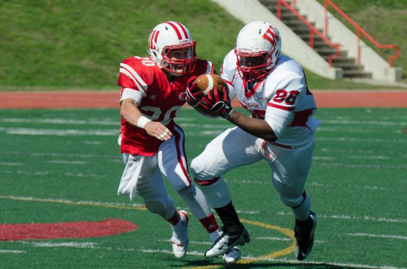 two football players running with the ball