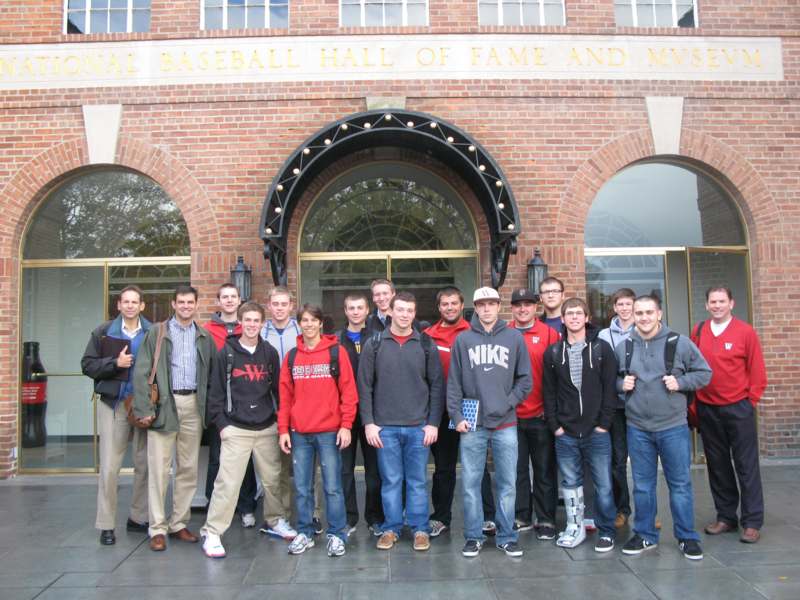 a group of people posing for a photo in front of a building