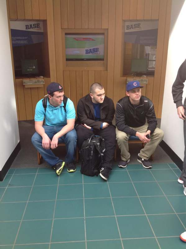 a group of men sitting in a hallway