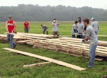 a group of people building a wood structure