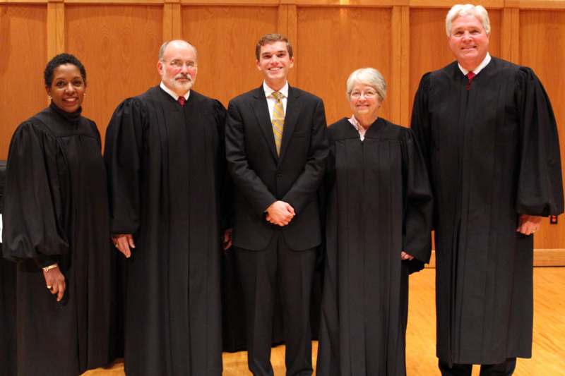 a group of people in black robes
