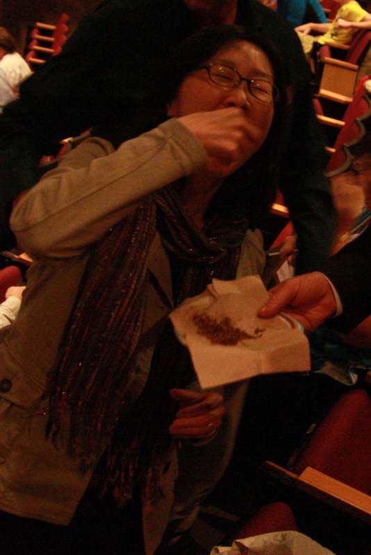 a woman eating food from a paper bag