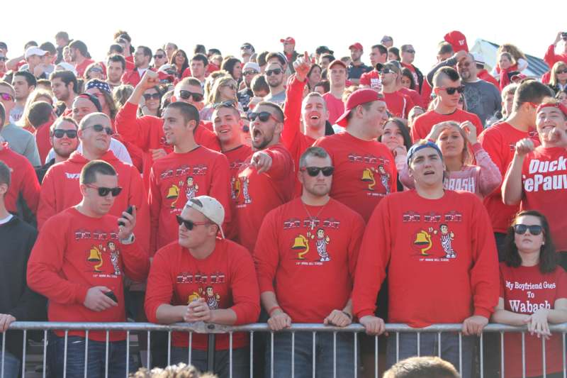 a group of people in red shirts