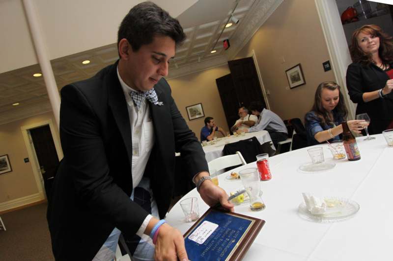 a man in a suit looking at a menu