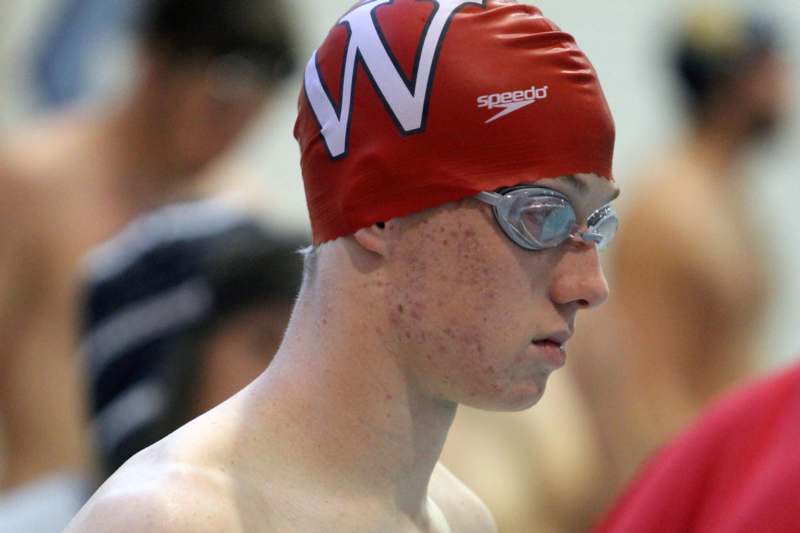 a person wearing a swim cap and goggles
