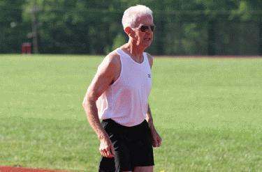 an old man in a tank top and shorts