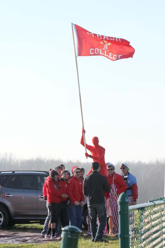 a person in a red garment holding a flag