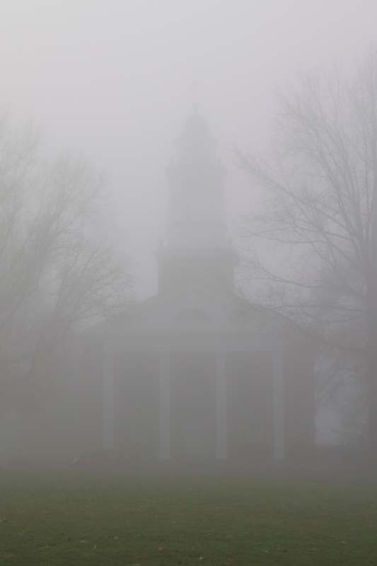 a building with a tower in the fog