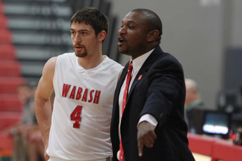 a basketball player talking to a coach