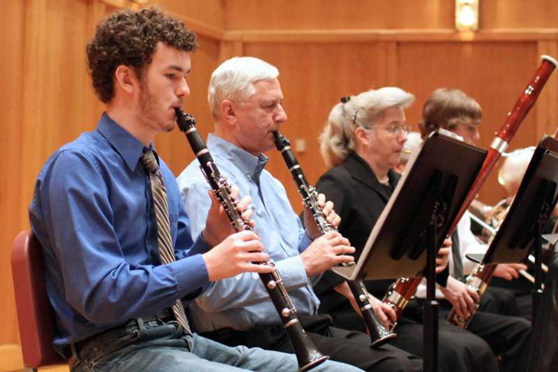 a group of people playing clarinets