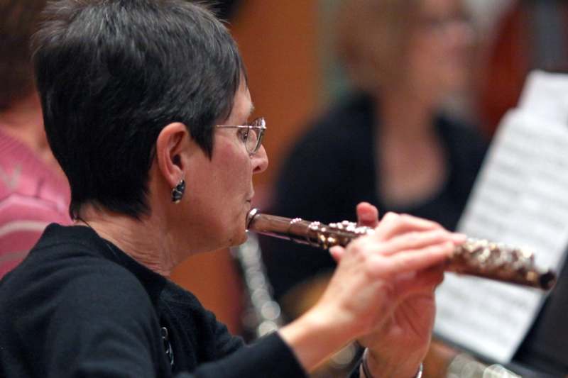 a woman playing a flute