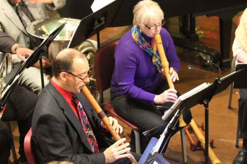 a man and woman playing flutes