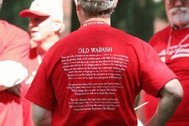 a man wearing a red shirt with text on it