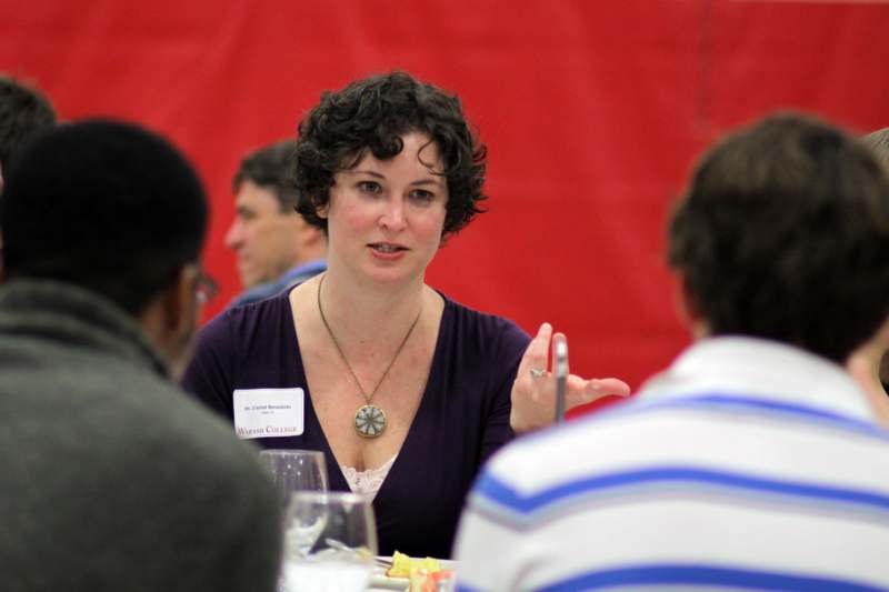 a woman talking to a group of people