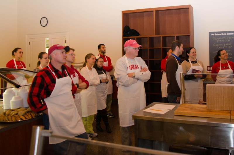a group of people wearing aprons standing in a room