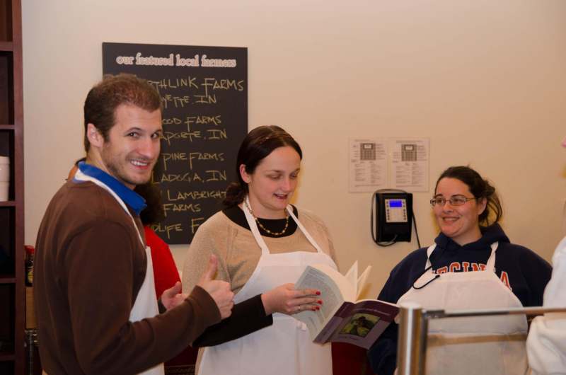 a group of people in aprons reading a book