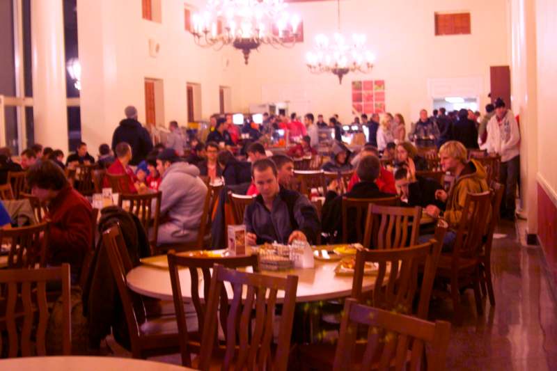 a group of people sitting at tables in a large room