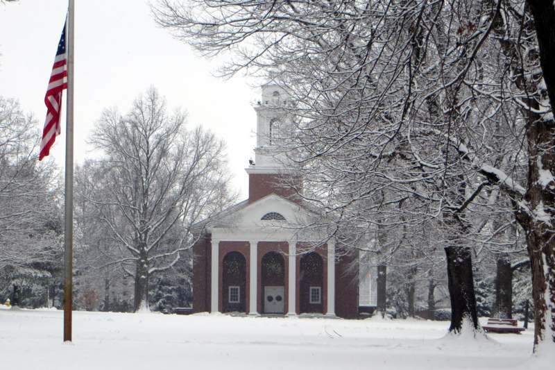a building with a bell tower in the snow