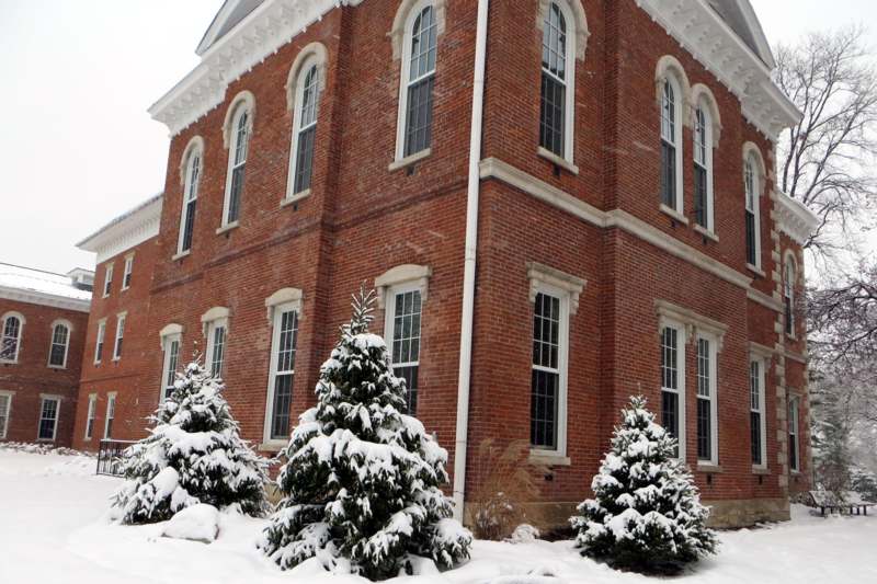 a brick building with snow on the ground