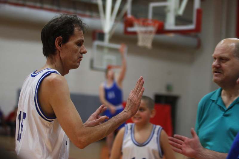 a man in a basketball uniform high fives