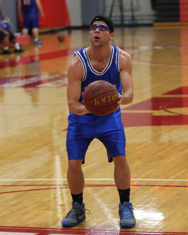 a man in blue shorts and blue shorts holding a basketball