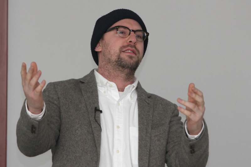 a man wearing glasses and a hat