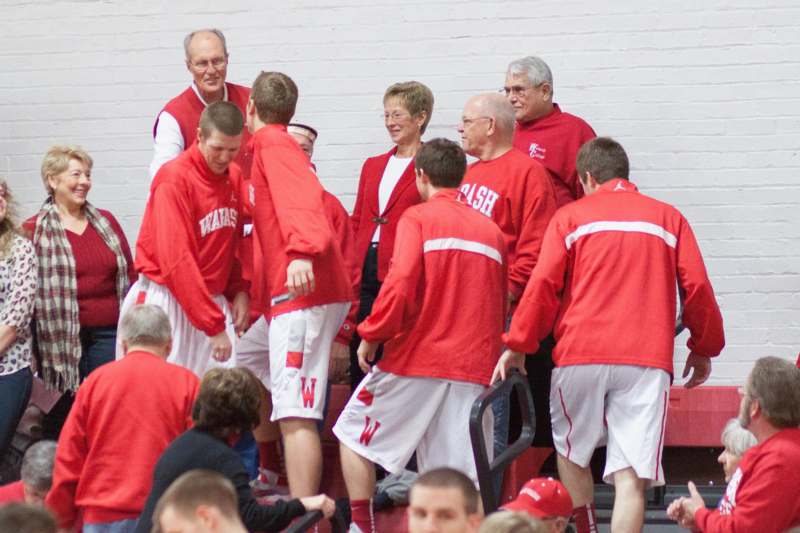 a group of people in red shirts