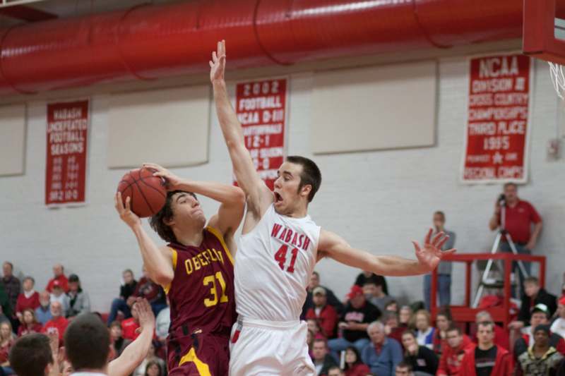 a basketball player in a red uniform playing basketball