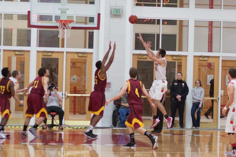 a group of men playing basketball
