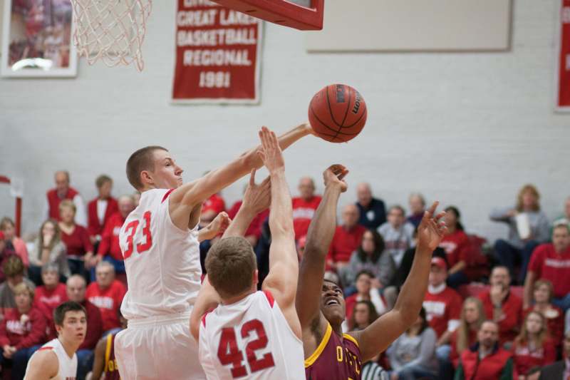 a group of men playing basketball