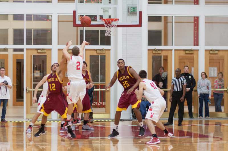 a group of men playing basketball