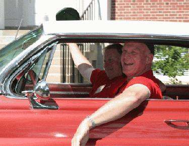 a couple of men in a red car