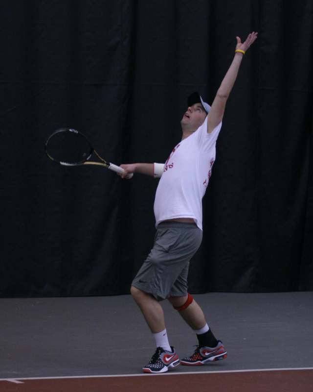 a man holding a tennis racket