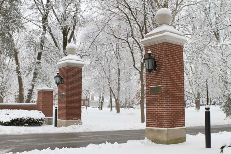 a brick pillars with snow on them
