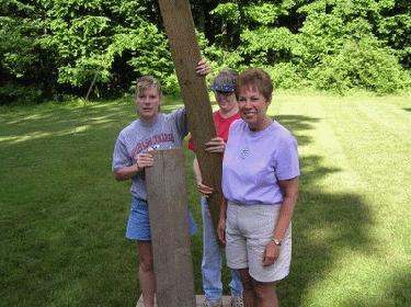 a group of people holding a wooden beam