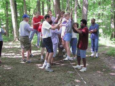 a group of people playing in the woods