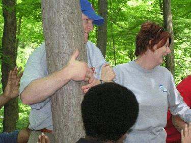 a group of people holding a tree