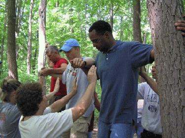 a group of people standing in a forest