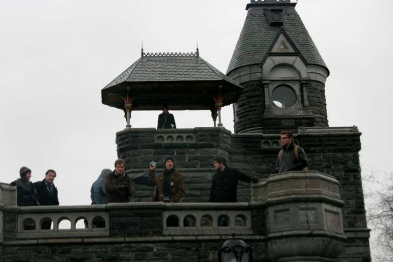 a group of people standing on a stone building