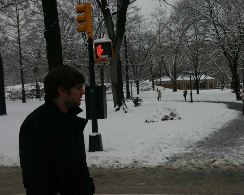 a man standing in a snowy park