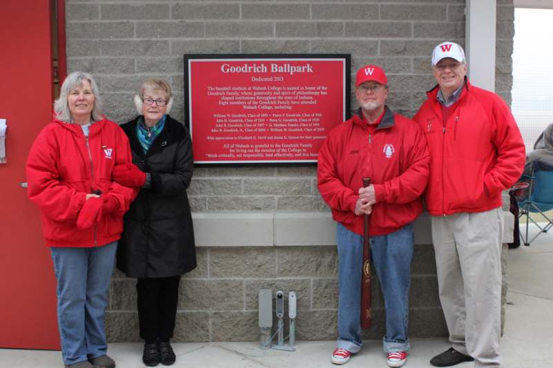 a group of people standing in front of a sign