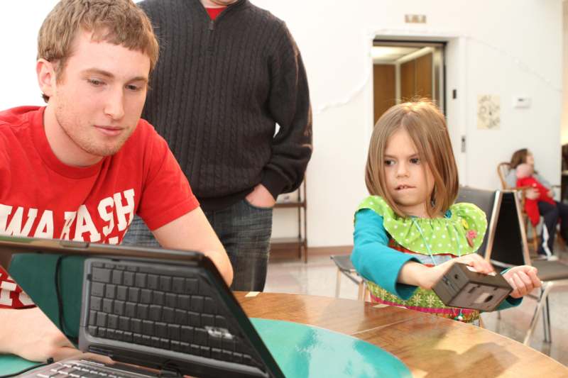 a man and a girl using a laptop