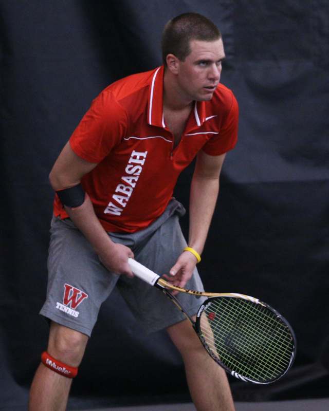 a man holding a tennis racket