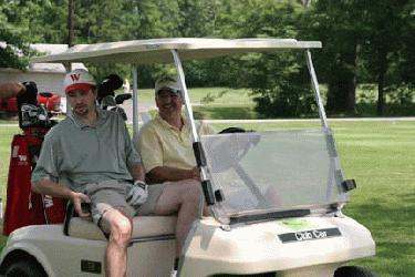 men sitting in a golf cart
