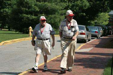 a couple of men walking on a sidewalk