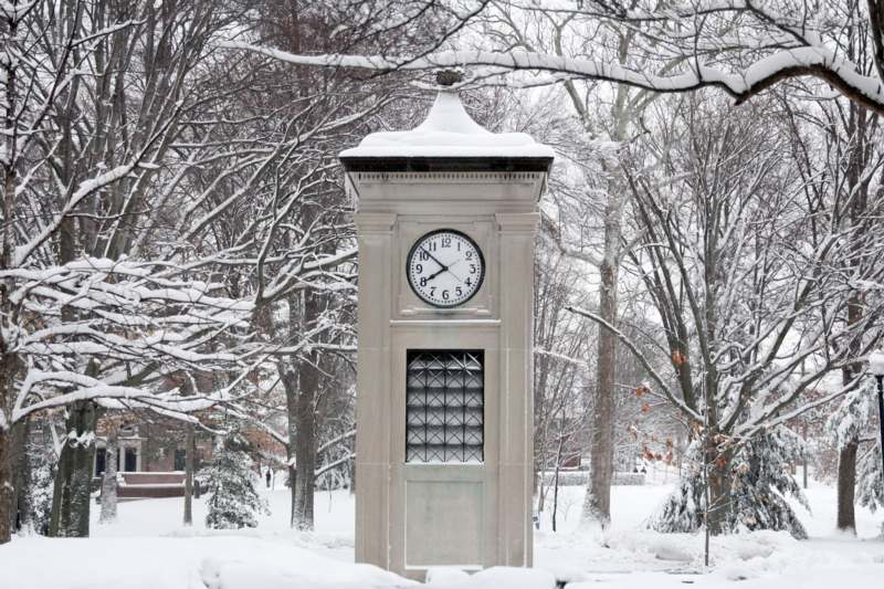 a clock tower in the snow