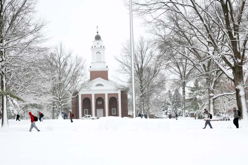 a building with a bell tower in the snow