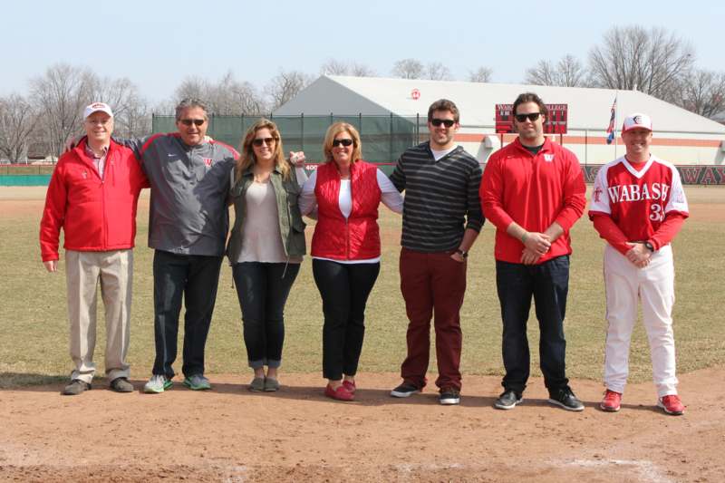 a group of people standing on a baseball field